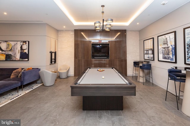 rec room featuring a raised ceiling and billiards