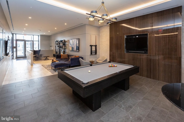 playroom with an inviting chandelier, pool table, and expansive windows