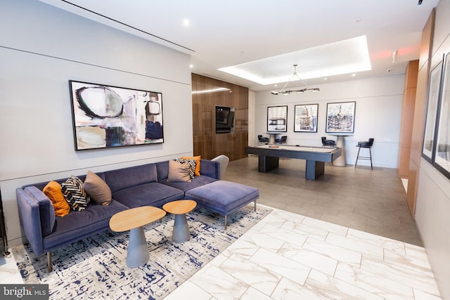 interior space with an inviting chandelier and a tray ceiling