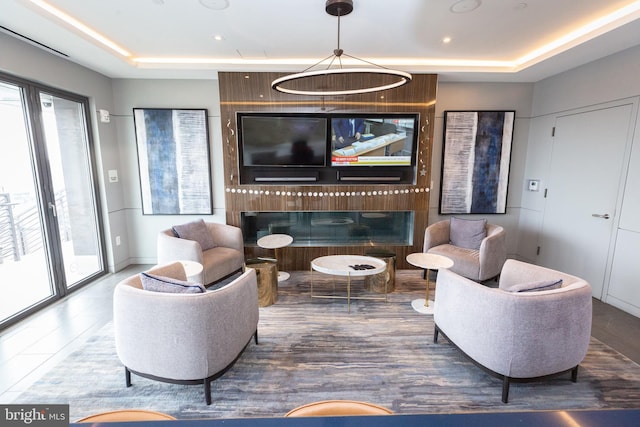 living room featuring a raised ceiling