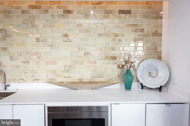 interior details featuring sink and white cabinets