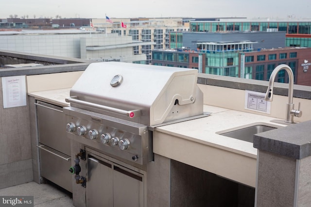 view of patio with a grill, area for grilling, and sink