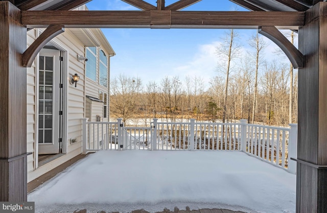 snowy yard with a deck