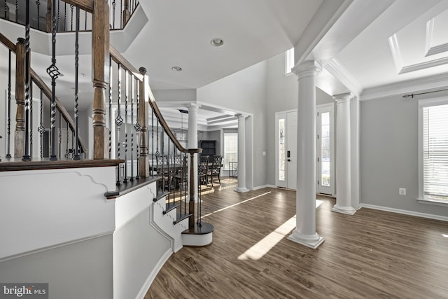 foyer featuring dark wood-type flooring, plenty of natural light, and crown molding