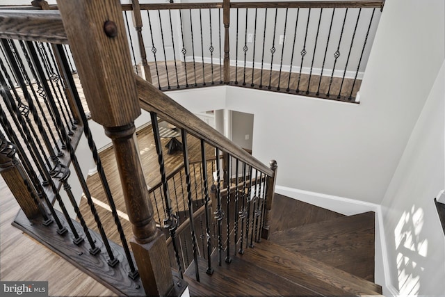 staircase with hardwood / wood-style floors