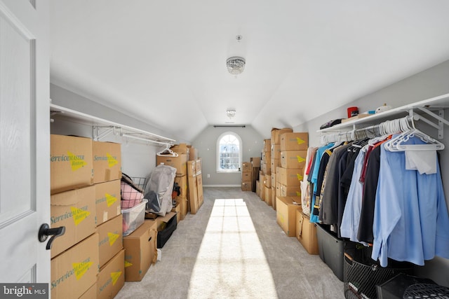 walk in closet featuring light colored carpet and vaulted ceiling