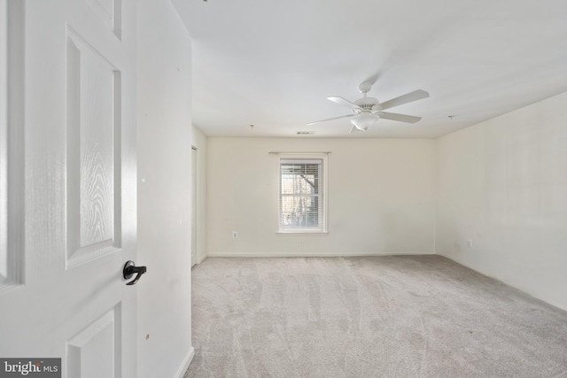 unfurnished room featuring light carpet and ceiling fan