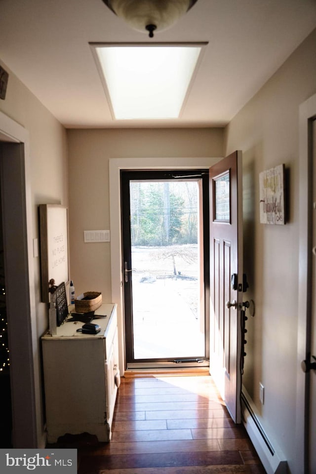 doorway featuring dark hardwood / wood-style flooring and a baseboard heating unit