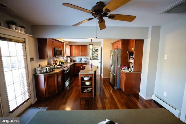 kitchen featuring a wealth of natural light, dark wood-type flooring, a baseboard radiator, and appliances with stainless steel finishes