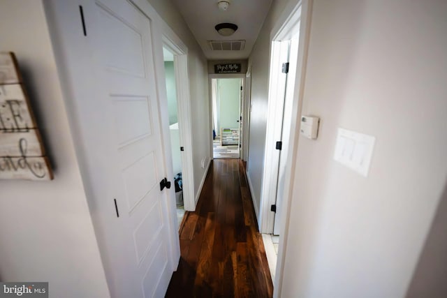 corridor featuring dark hardwood / wood-style flooring