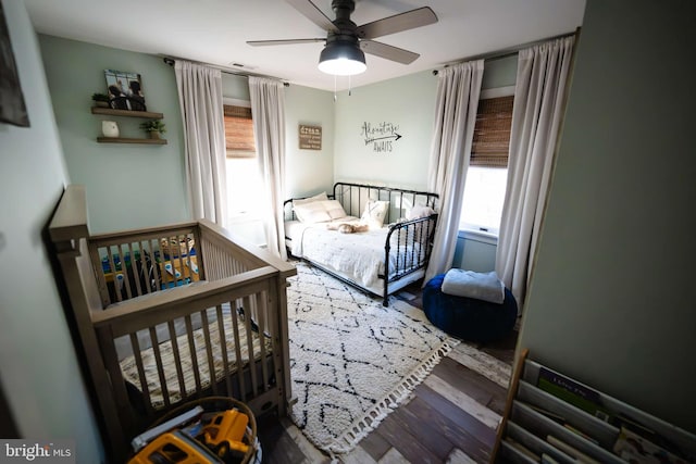 bedroom with ceiling fan and wood-type flooring