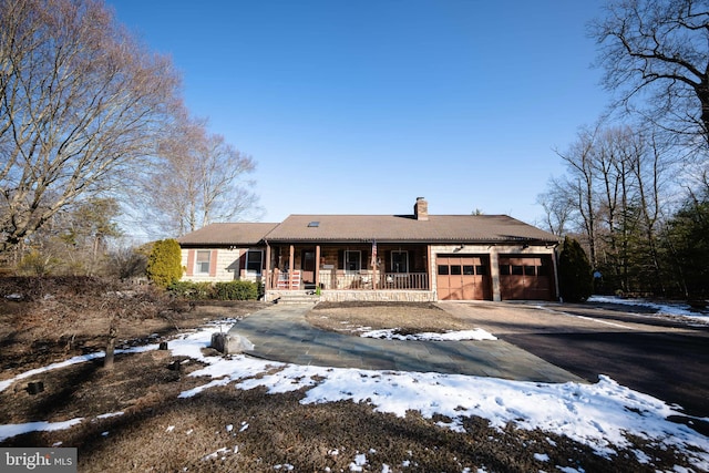 ranch-style home featuring a porch and a garage