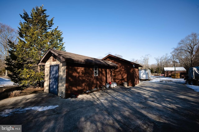 view of side of home featuring an outbuilding