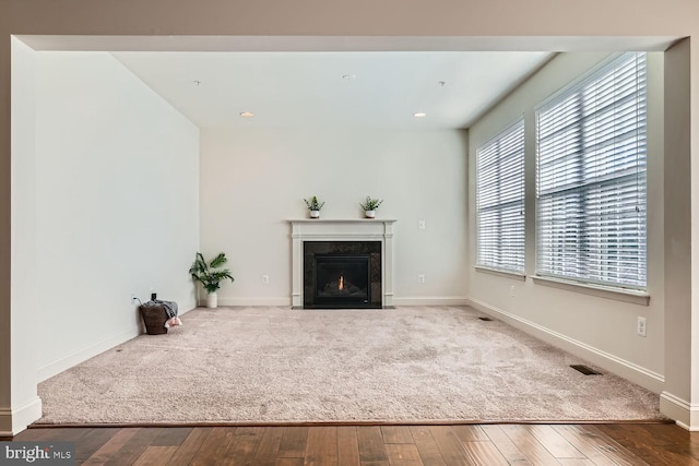 unfurnished living room with a high end fireplace