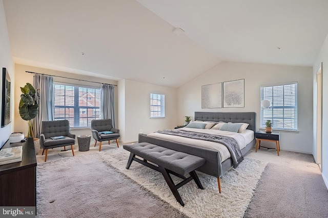 bedroom featuring lofted ceiling and light colored carpet