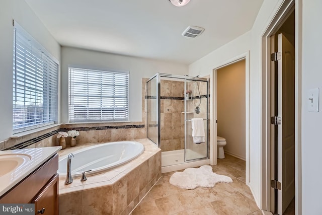 full bathroom with toilet, vanity, tile patterned floors, and plus walk in shower