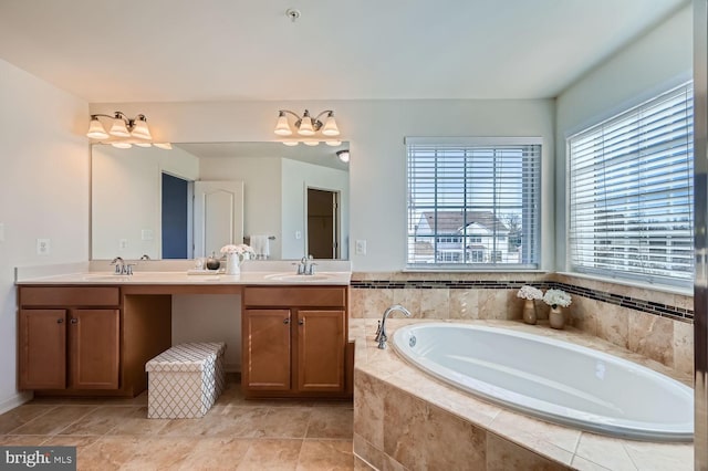 bathroom featuring tiled bath and vanity