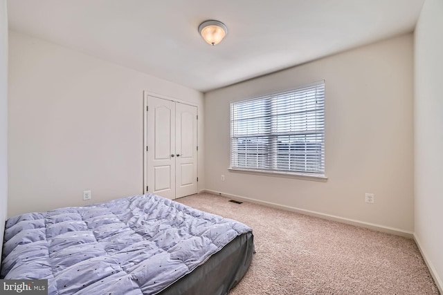 carpeted bedroom featuring a closet