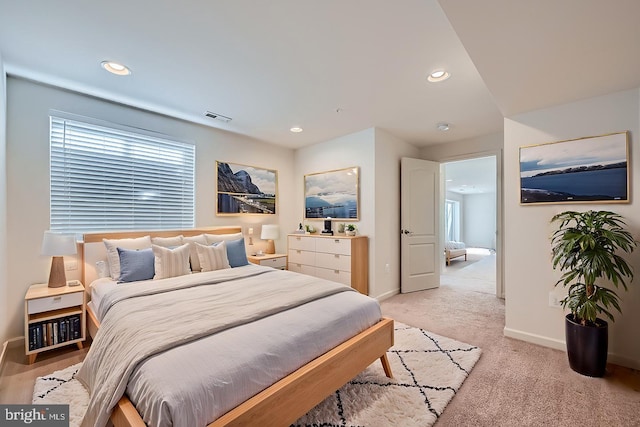 bedroom featuring light colored carpet