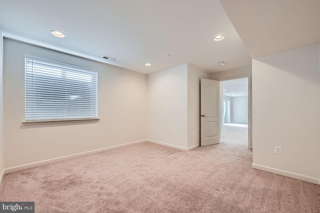 unfurnished room featuring light colored carpet