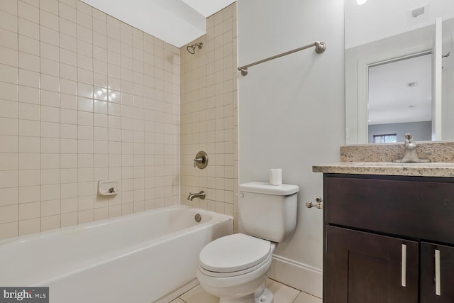 full bathroom featuring toilet, vanity, tile patterned floors, and tiled shower / bath combo