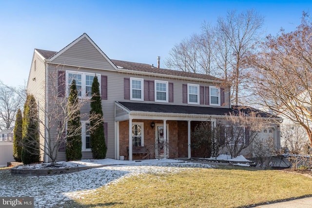 front facade featuring covered porch and a front lawn