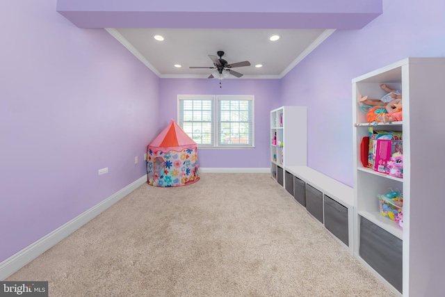 rec room featuring ceiling fan, crown molding, and carpet floors