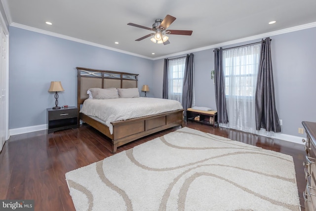 bedroom with ceiling fan, dark hardwood / wood-style floors, and ornamental molding