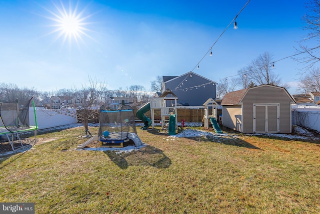 view of yard featuring a playground, a storage unit, and a trampoline