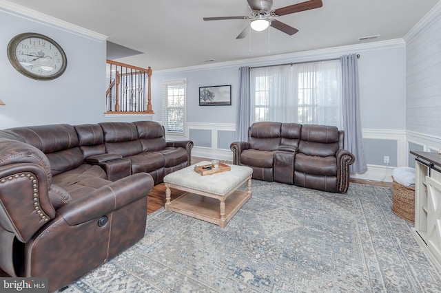 living room with hardwood / wood-style flooring, ceiling fan, and crown molding