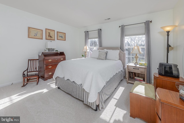 bedroom featuring light colored carpet