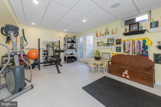 workout room featuring a paneled ceiling and french doors