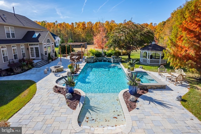 view of swimming pool featuring an in ground hot tub, a gazebo, french doors, a patio, and a fire pit