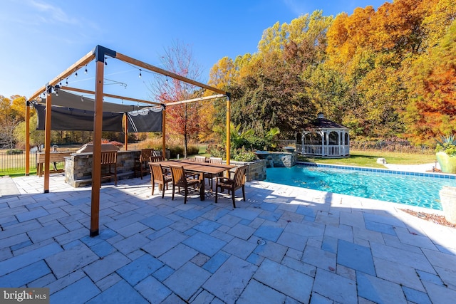 view of pool featuring exterior bar, a patio, a jacuzzi, and a gazebo