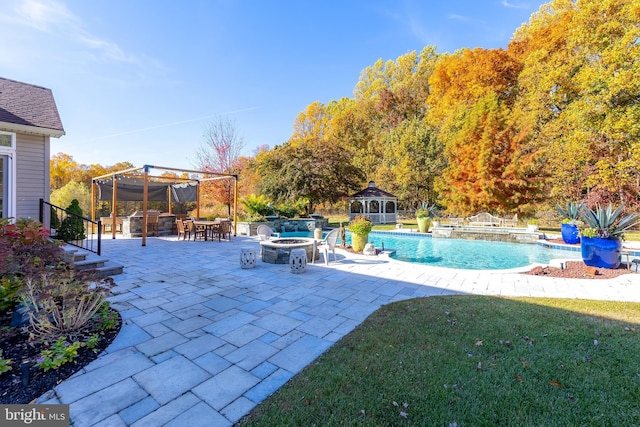 exterior space with a patio, a hot tub, a gazebo, a bar, and an outdoor fire pit