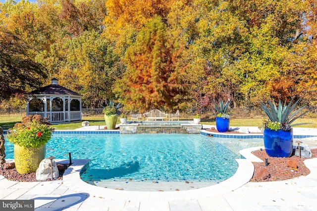 view of swimming pool featuring a gazebo and an in ground hot tub