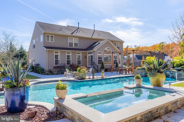 back of property with a pool with hot tub and a patio