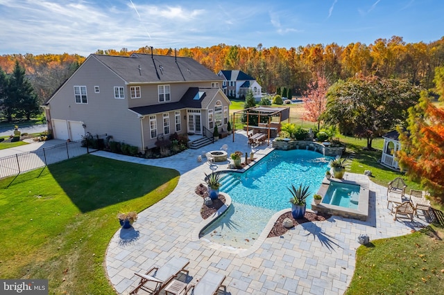 view of pool featuring an outdoor fire pit, pool water feature, a patio area, a gazebo, and a yard