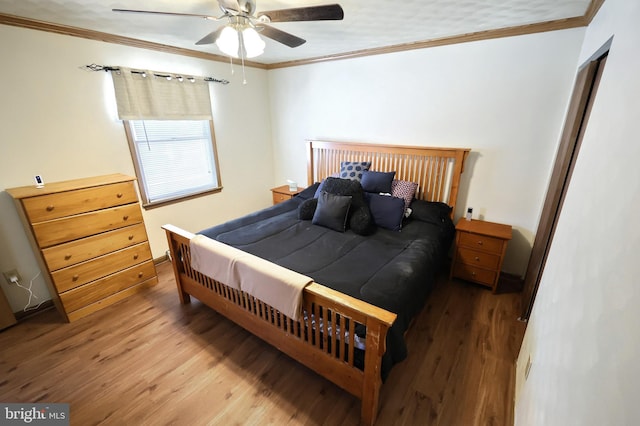 bedroom with ceiling fan, wood-type flooring, and ornamental molding