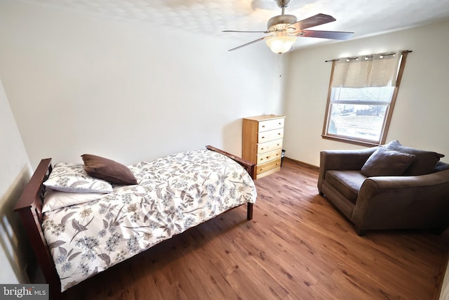 bedroom with hardwood / wood-style flooring and ceiling fan