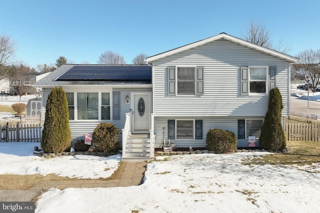 split level home with solar panels