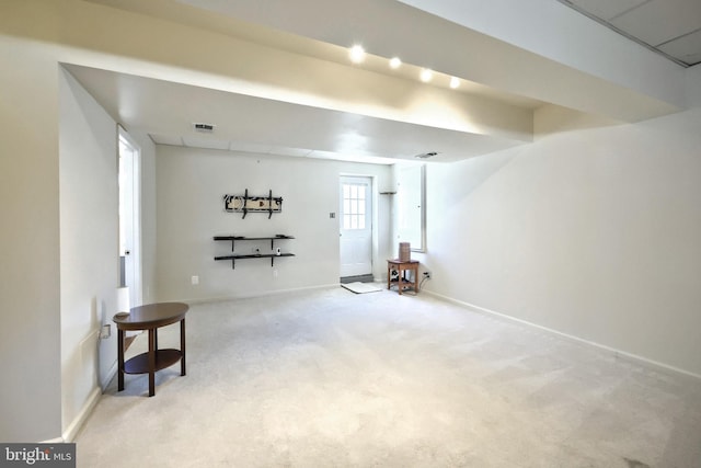 basement featuring light carpet