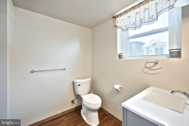 bathroom featuring vanity, hardwood / wood-style flooring, and toilet