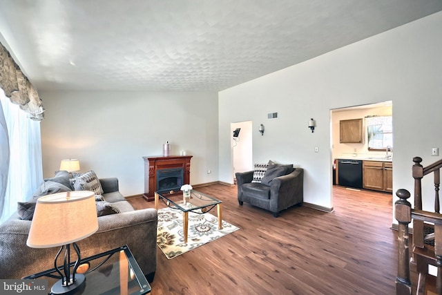 living room with hardwood / wood-style flooring, sink, and a wealth of natural light