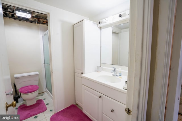 bathroom with walk in shower, vanity, and toilet