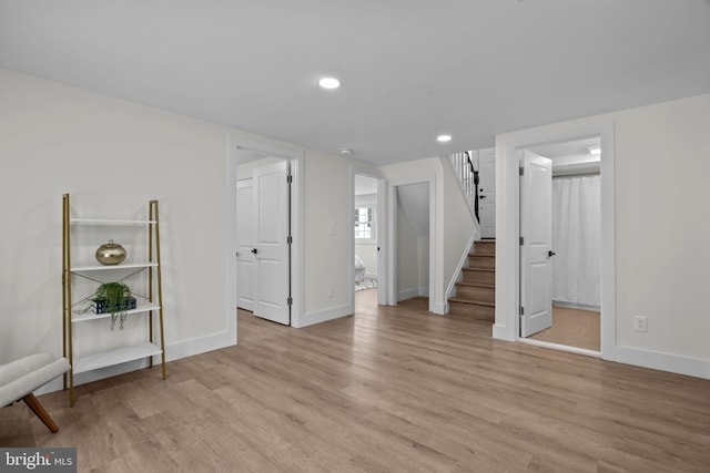 basement with light hardwood / wood-style flooring