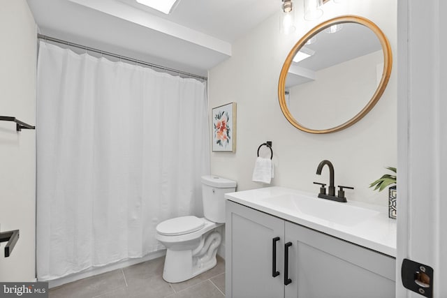 bathroom featuring tile patterned floors, vanity, and toilet