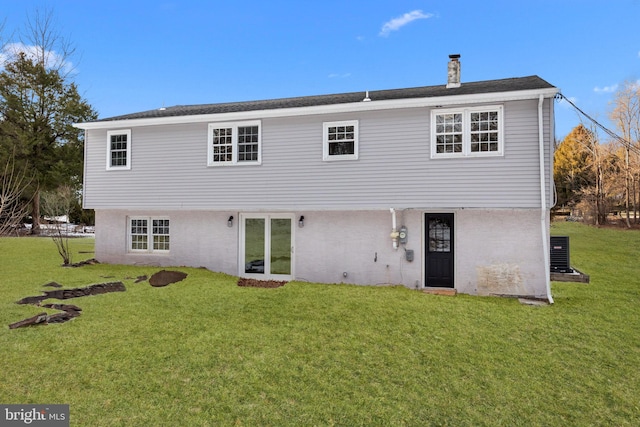 rear view of house featuring a yard and cooling unit