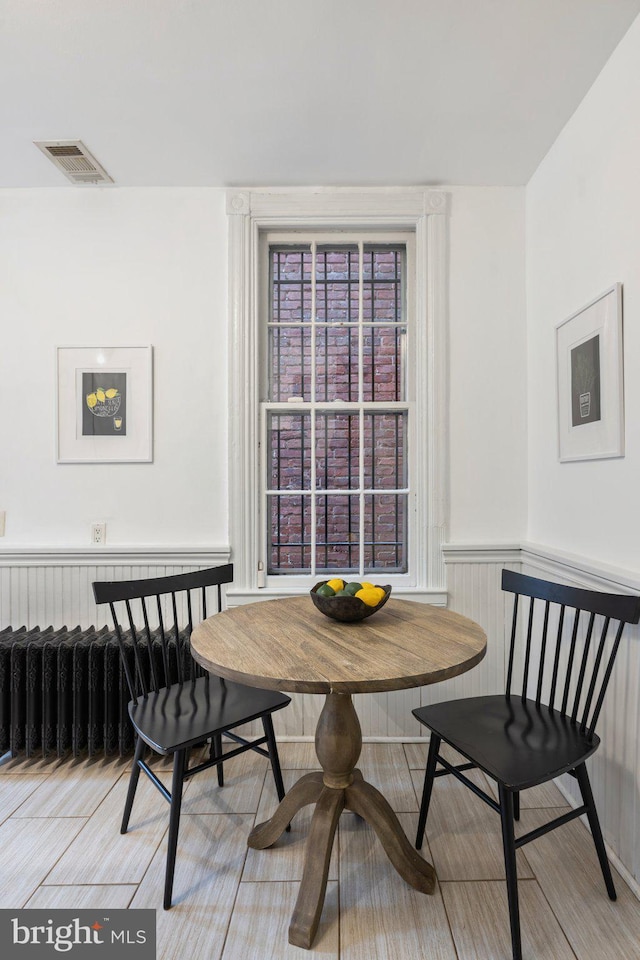 dining area featuring breakfast area and radiator heating unit