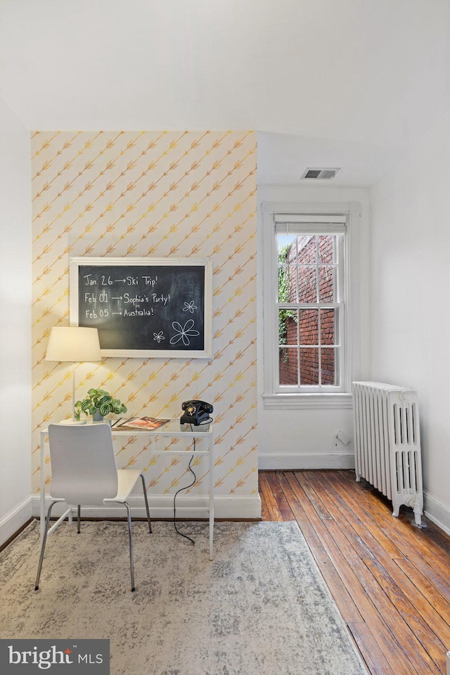 home office with radiator and wood-type flooring